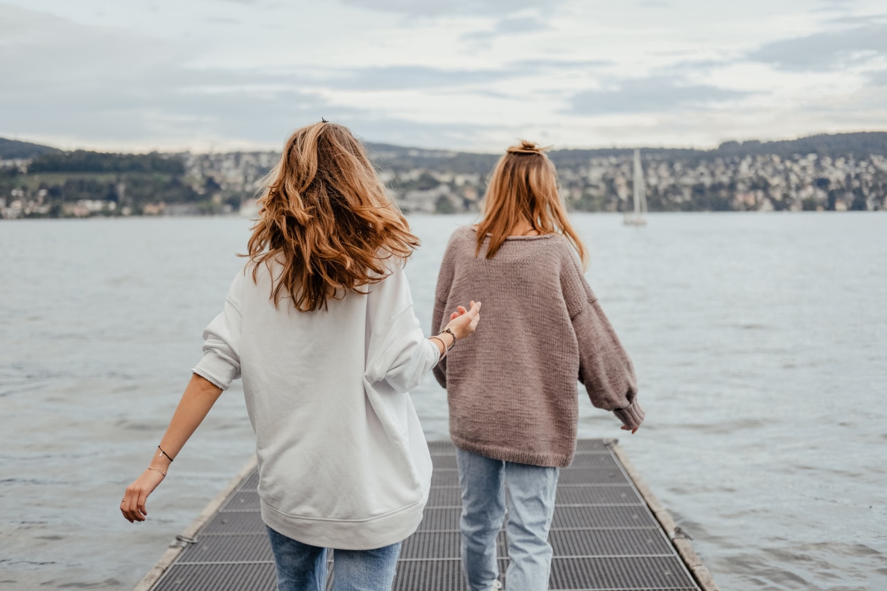 two women, friends, walking, lake